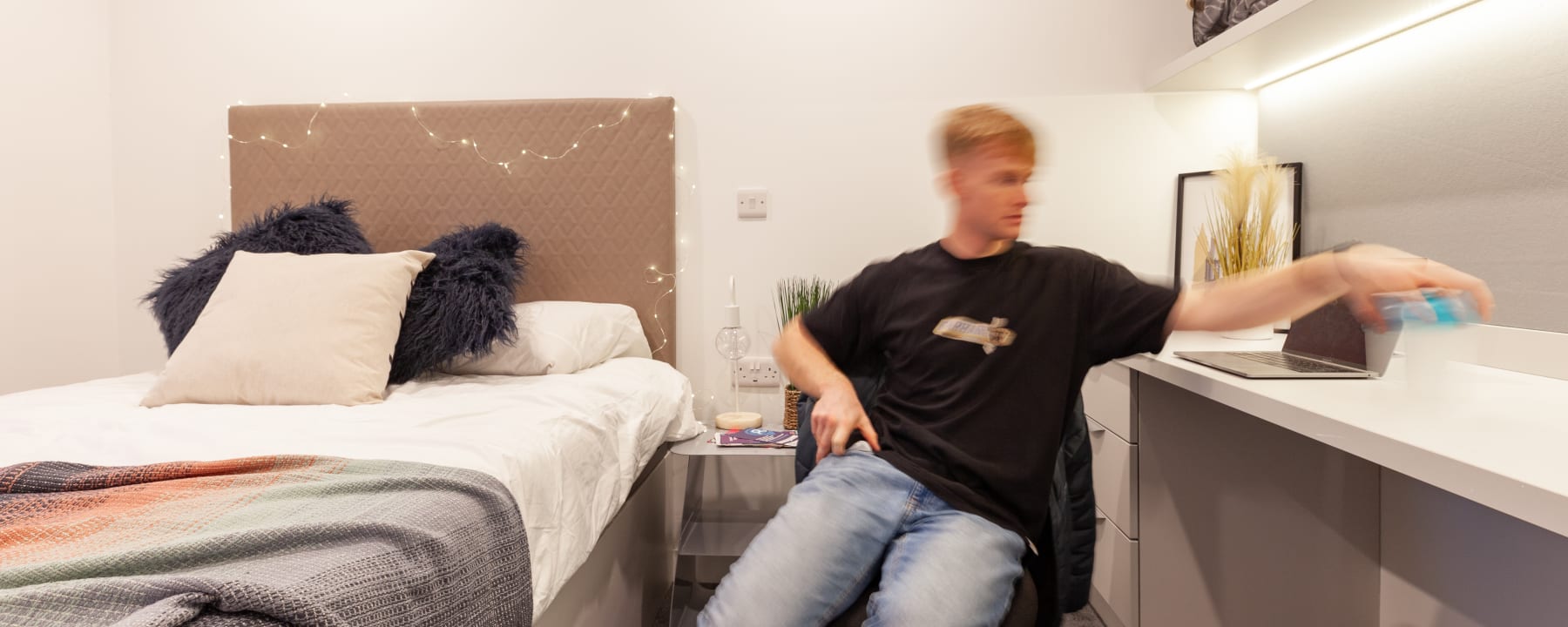 Student sat at a desk on their laptop