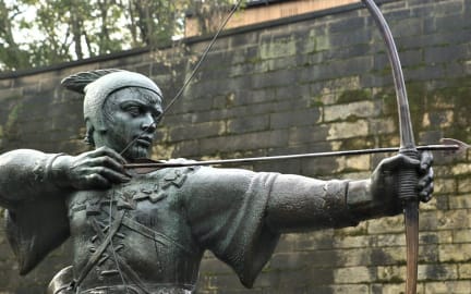 Statue of Robin Hood with a bow and arrow in Nottingham