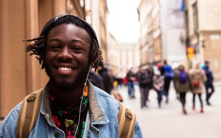 Close up of male student smiling in the street