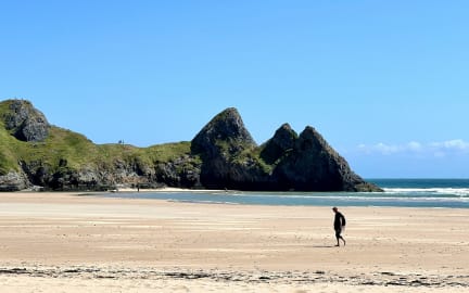 Man walking on the beach in Swansea