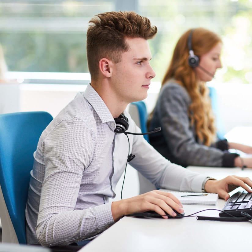 A phone operative working at his desk in the SmartSearch office