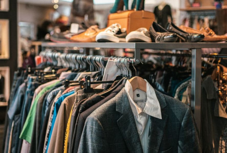 Rails of clothes inside a charity shop