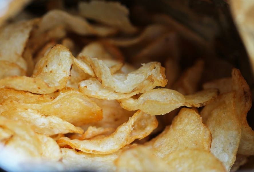 Open bag of potato crisps