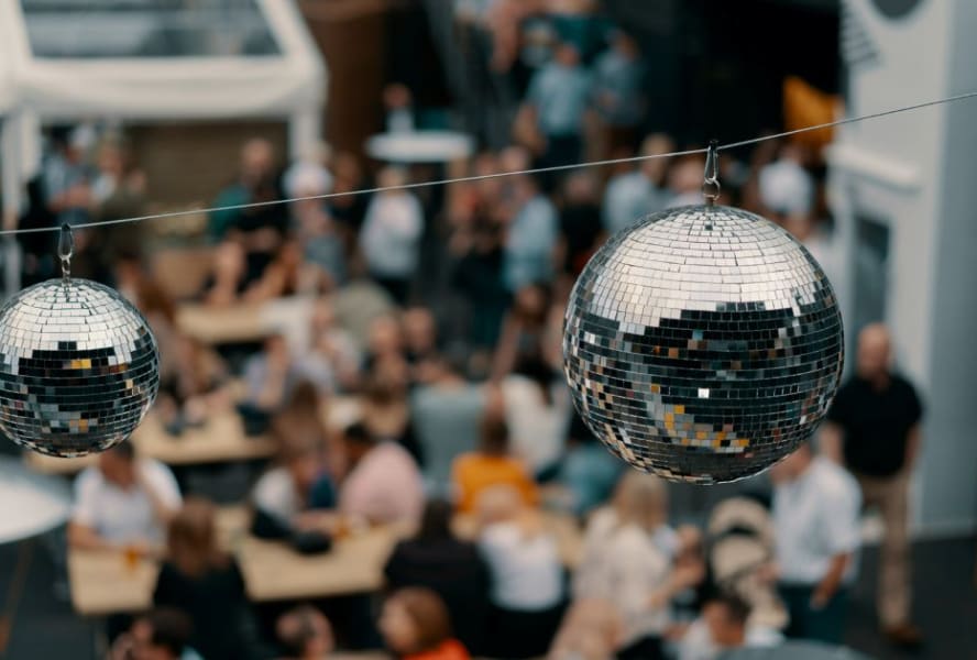 Close up of disco ball decorations above student party
