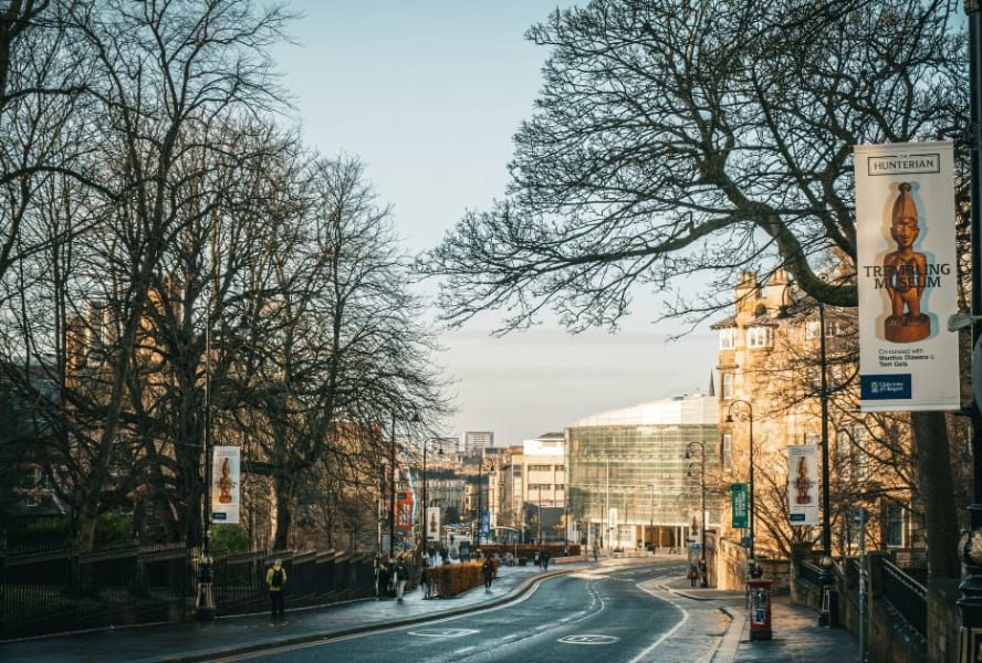 Road in Glasgow with banners advertising the museum