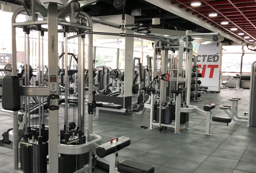 Grey and black gym with machines.