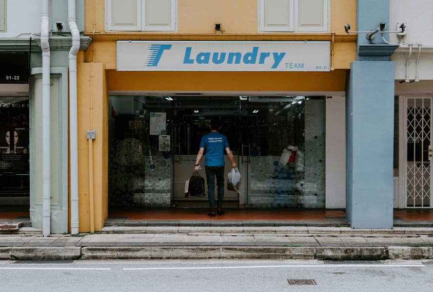 Laundrette shop exterior with man entering.