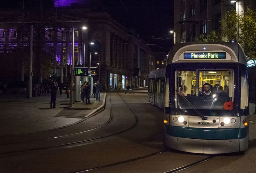 Phoenix Park tram travelling through Nottingham at night.