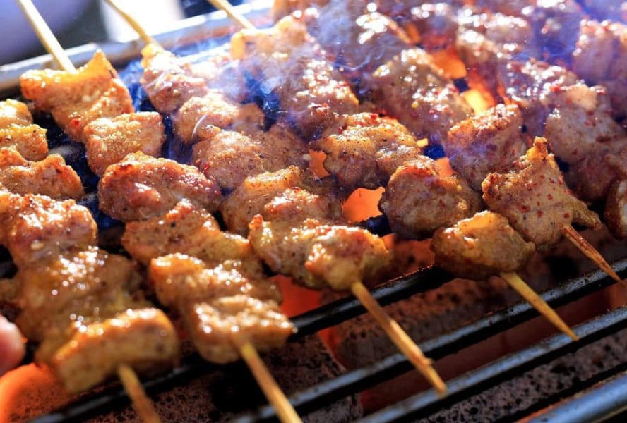 Skewers simmering on a BBQ