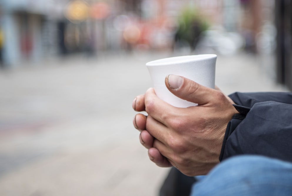 A person holding a paper cup