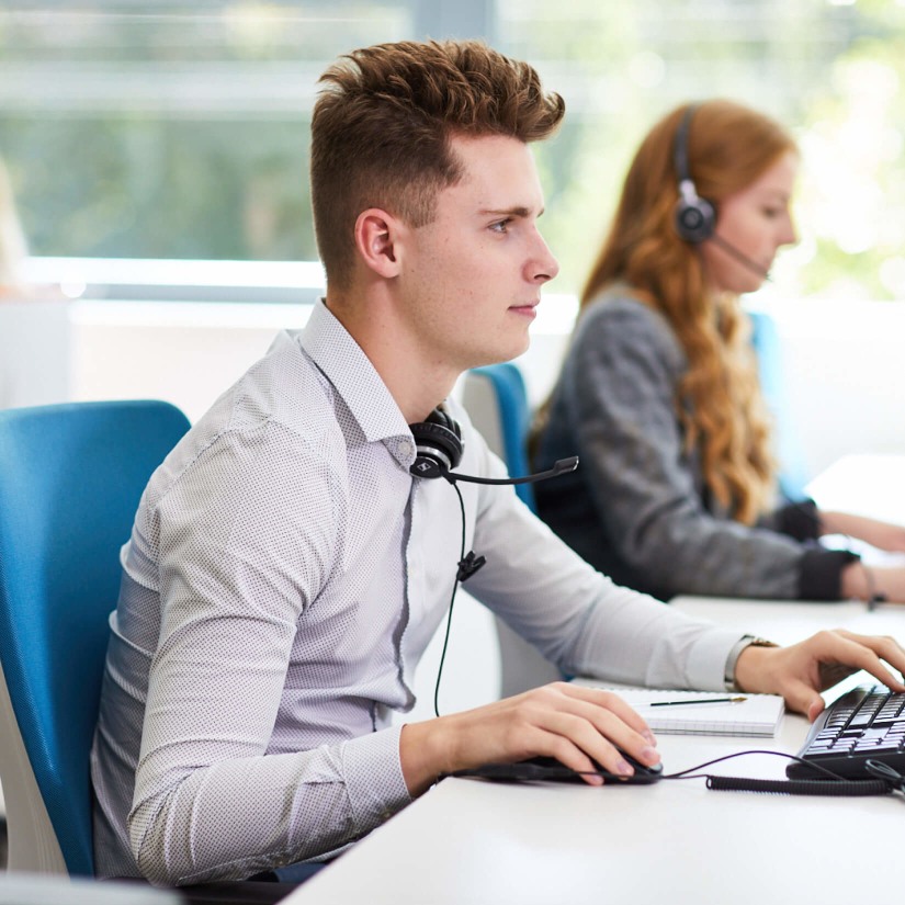 A phone operative working at his desk in the SmartSearch office