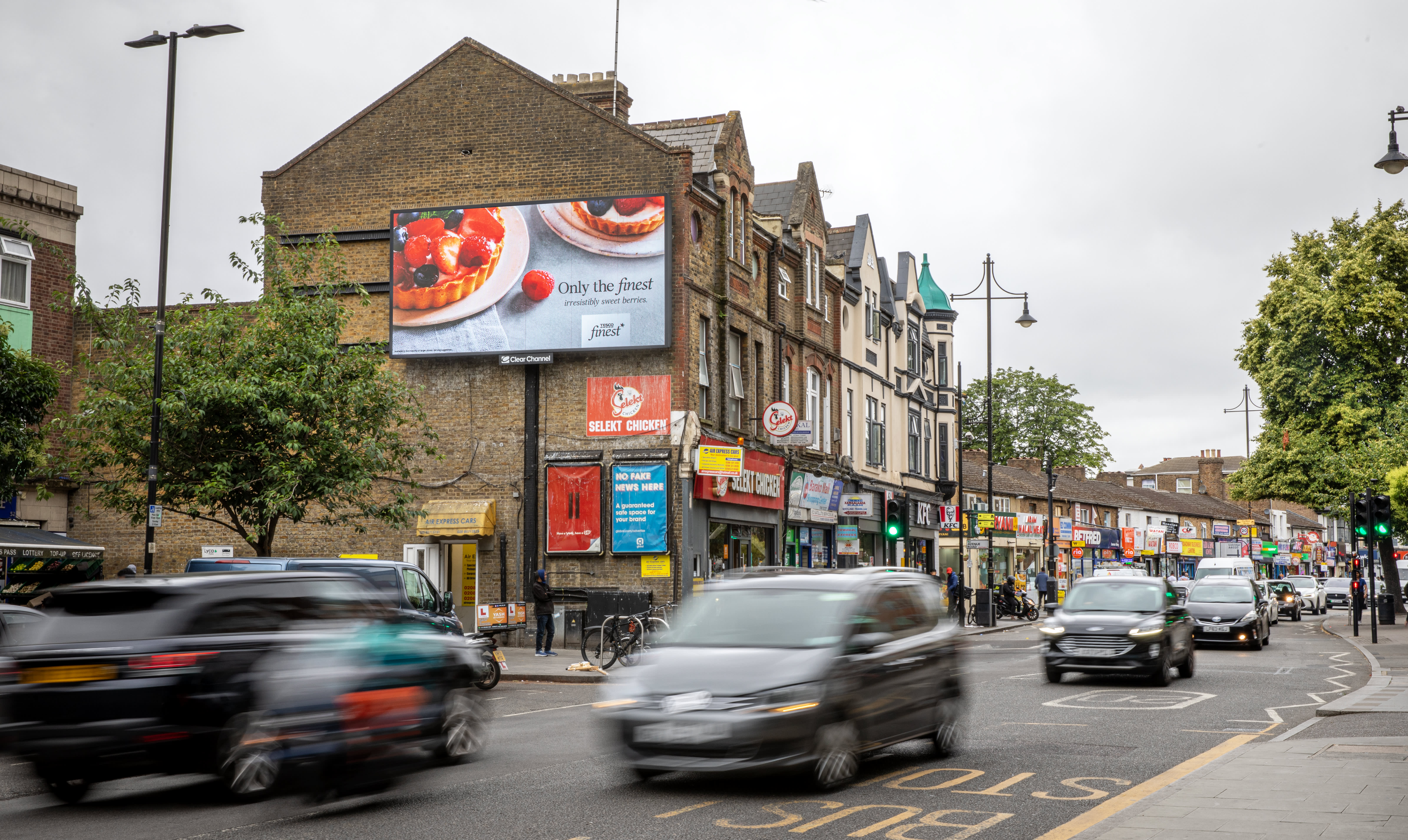 A Tesco campaign on a billboard live screen.