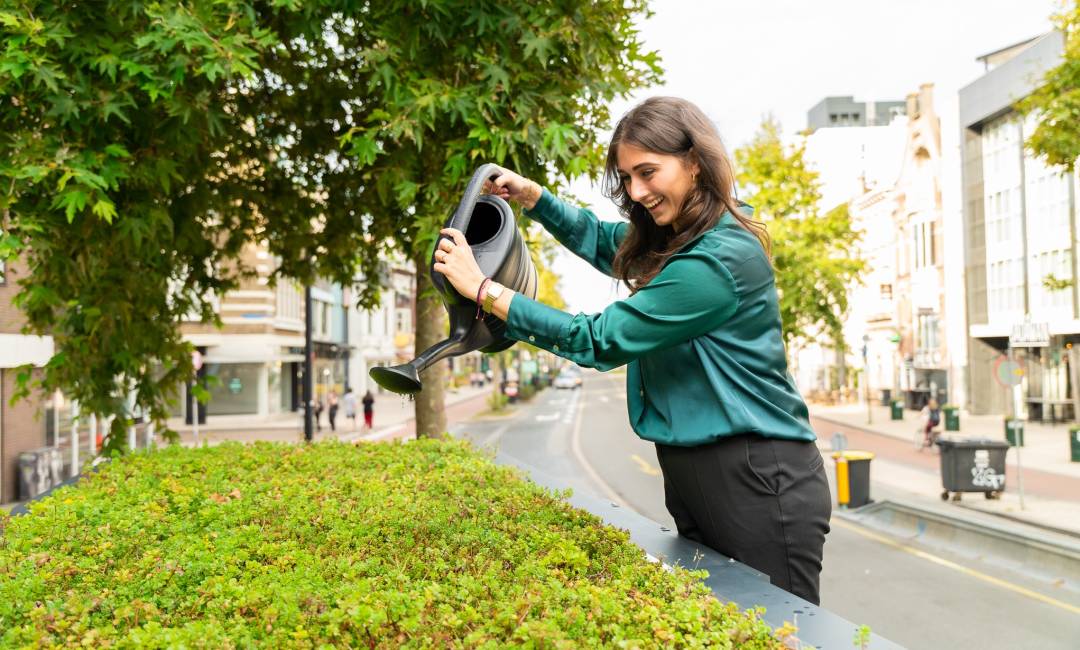 Anika Ramamurthy, Sustainability Manager at Clear Channel, watering a Living Roof