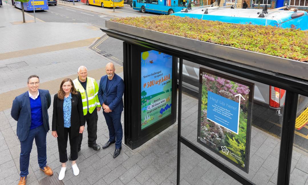 Aerial Shot of  Clear Channel and Wildlife Trust employees standing next to a living roof