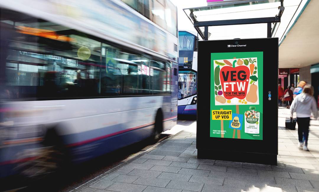 Adshel screen on side of bus shelter displays 'veg ftw' image