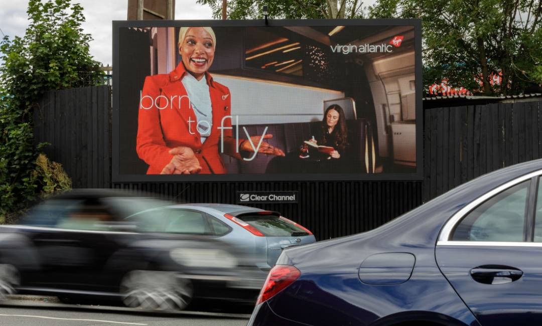 Virgin Atlantic ad featuring air hostess or large digital billboard