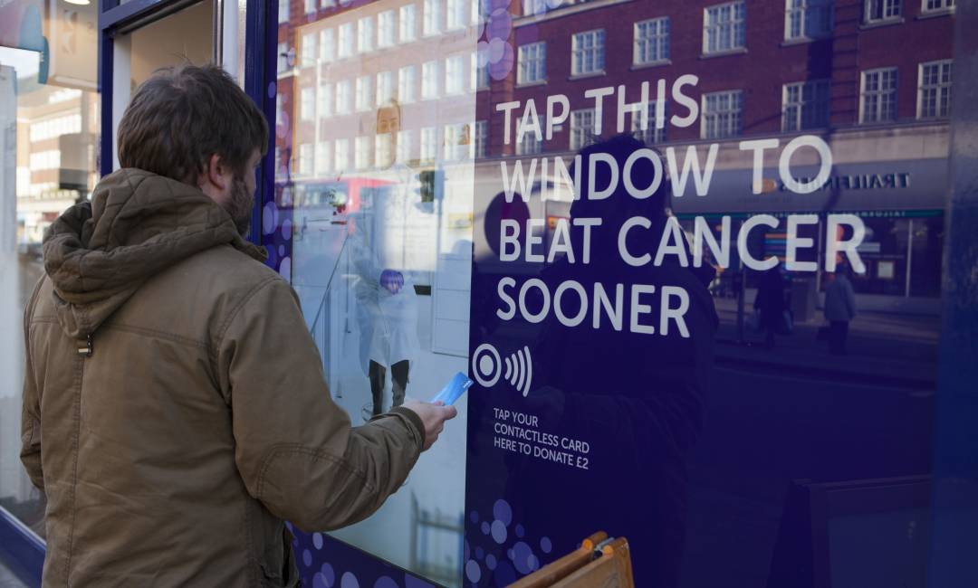 An image of a cancer research shop that has a contactless pay option.