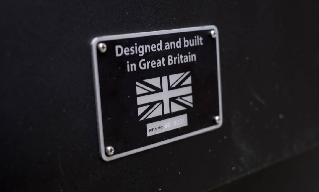 Close up of Clear Channel Phone Kiosk plaque showing Union Jack logo with the words Designed and Built in Great Britain