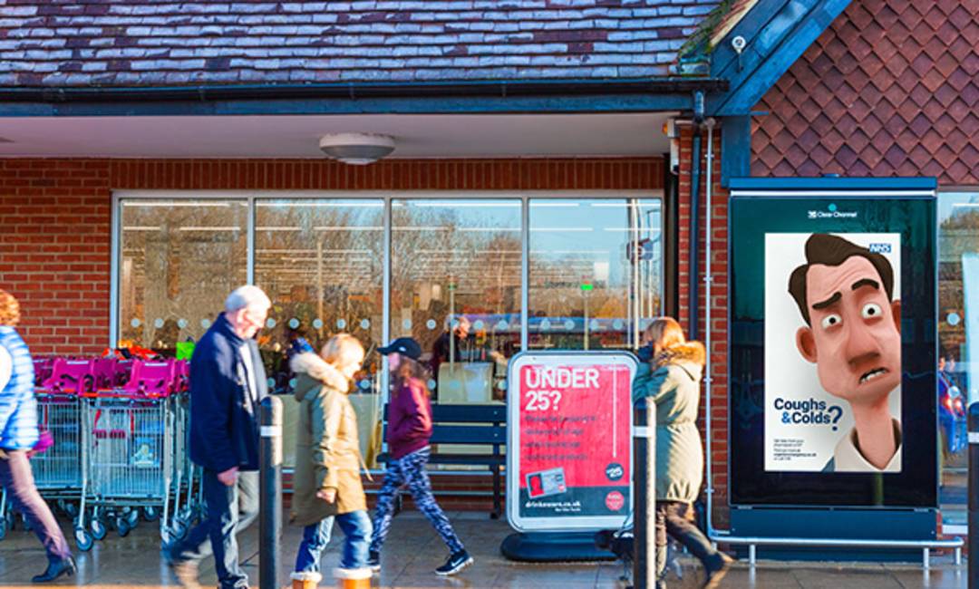 Supermarket digital screen in the rain featuring a cough & cold ad