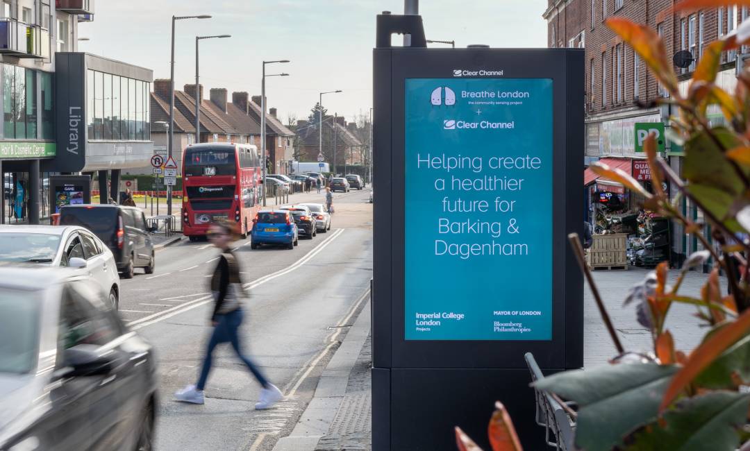 Clear Channel Adshel Live screen with an air quality sensor on a busy street in Dagenham