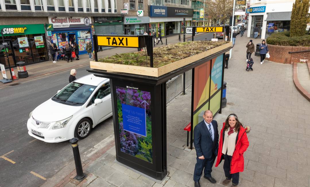 Clear Channel's, Chris Mclelland, and Worthing Council's, Vicki Wells, during the day, standing in front of a brand new taxi shelter with a Living Roof on top