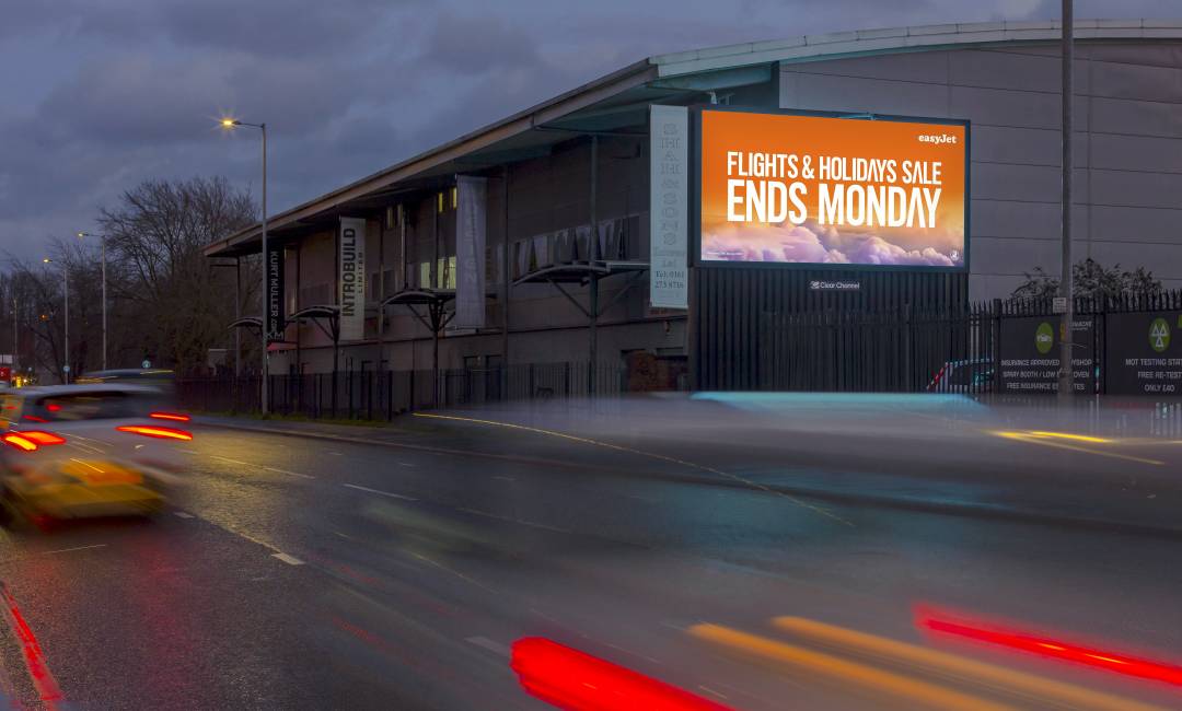 A building with a large billboard live screen advertising easy jet.