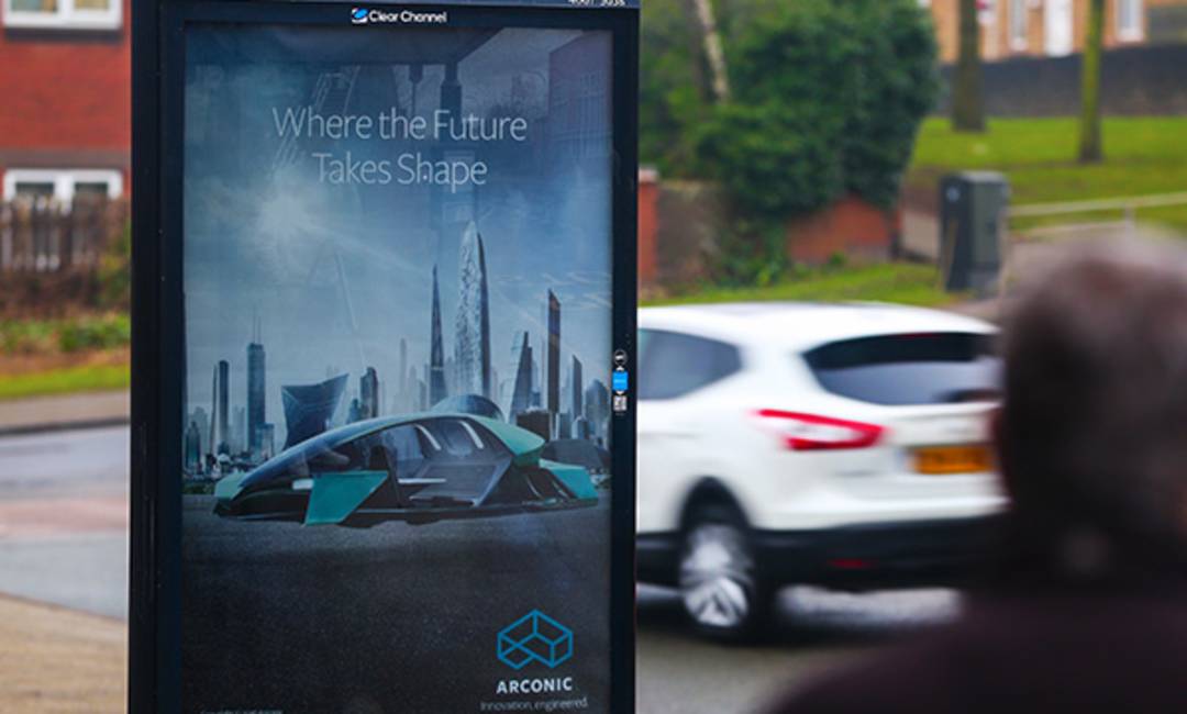 Arconic's ad as a car and person walk past