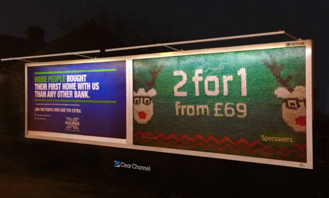 Double Billboard displays Specsavers and Halifax imagery at night