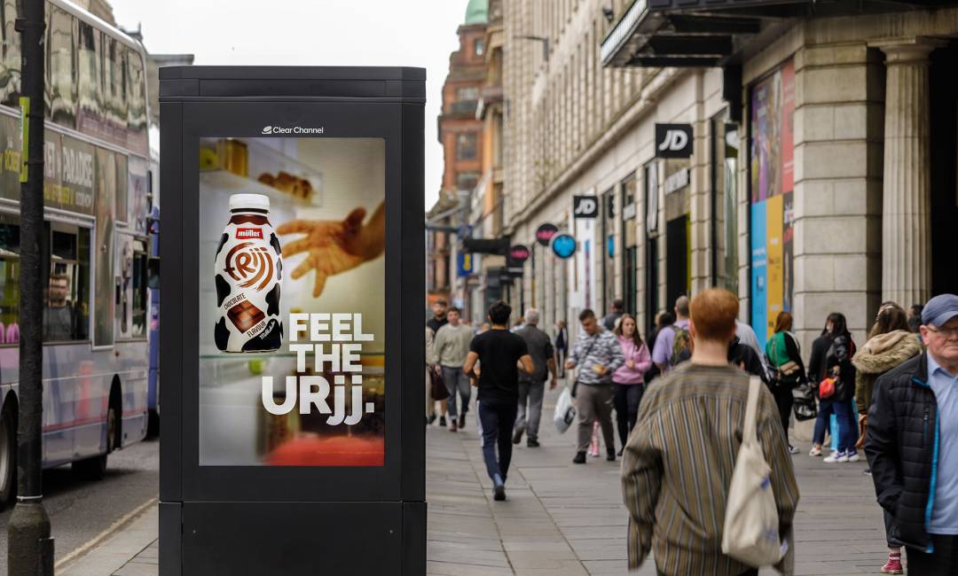 Milkshake poster with big bold copy and clear pack shot on a digital screen on the high street