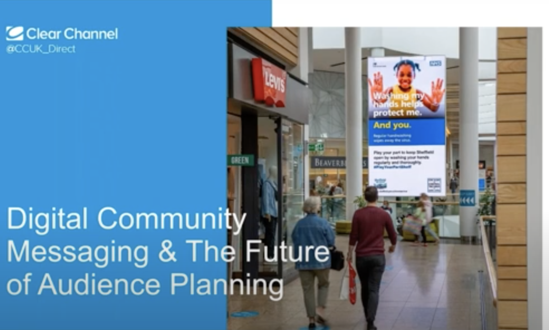 People in a shopping mall walking towards a large Digital Out of Home screen next to the webinar title