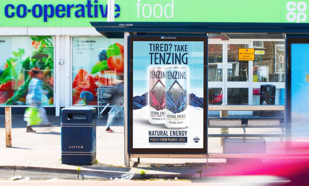 Adshel screen outside Co-op store showing Tenzing Natural Energy drink.