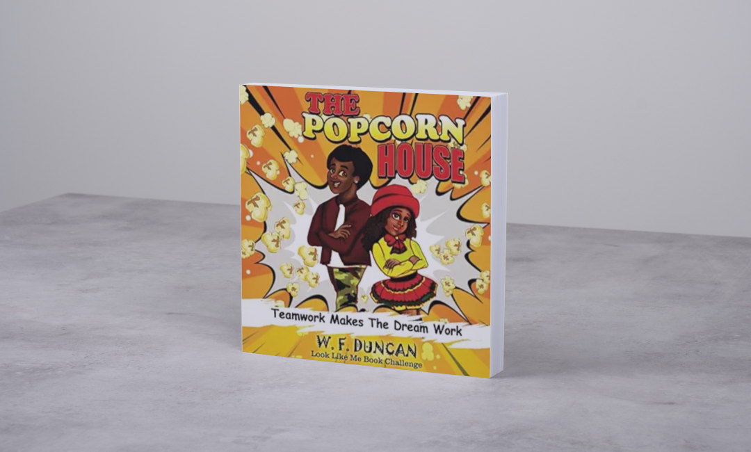 A children's book entitled 'The Popcorn House' displayed on a gray table with a white background