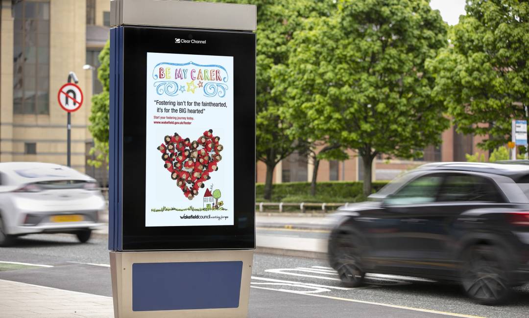 Clear Channel digital screen on a busy road showing ad for Wakefield Council