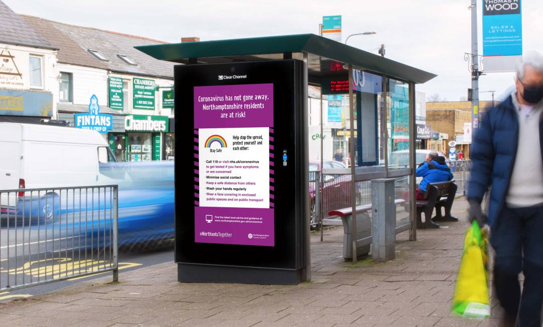 Welsh Governments's Bus Shelter ad with people walking past