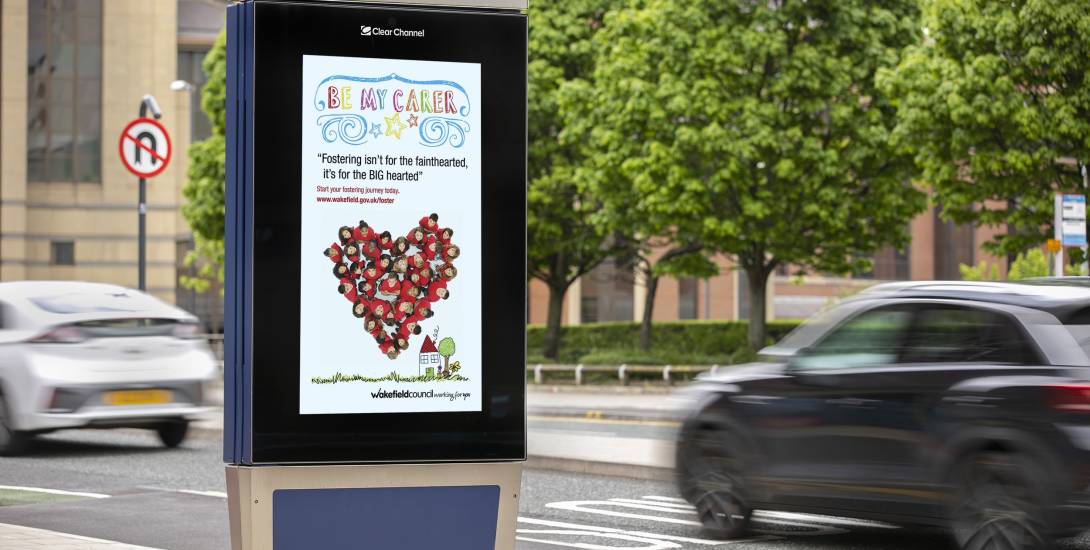 Clear Channel digital screen on a busy road showing ad for Wakefield Council