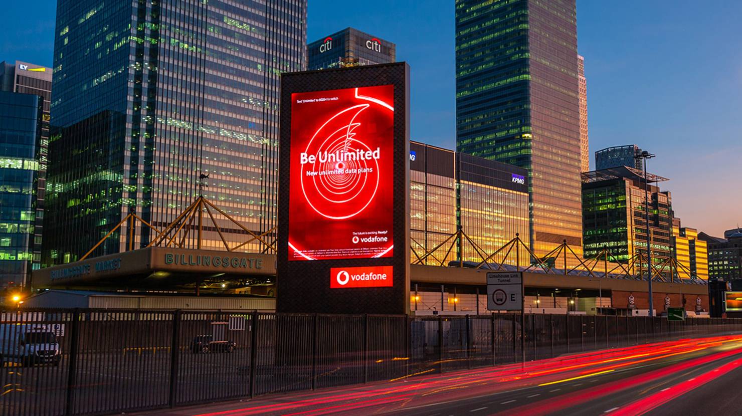Mobile brand on a premium large format digital billboard at sunset