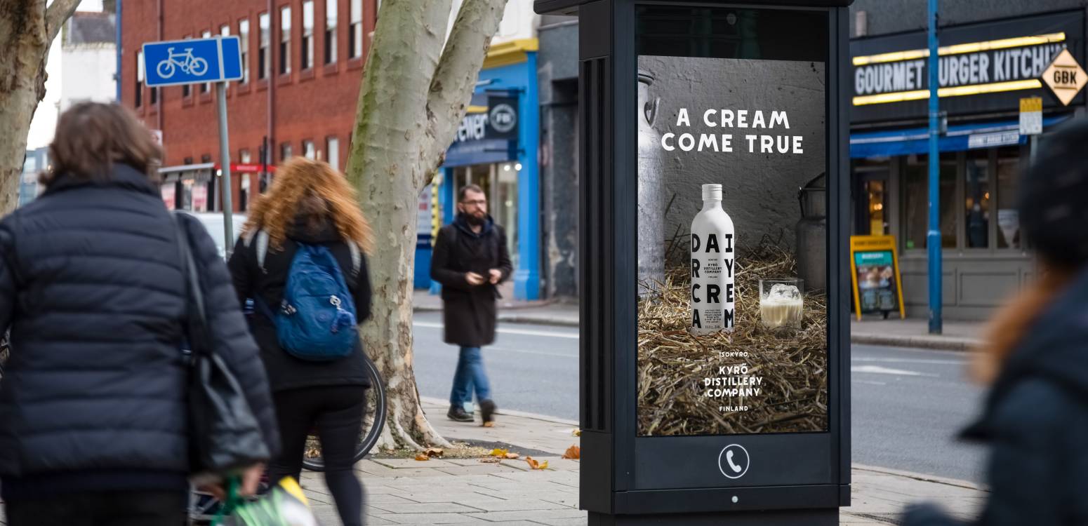 Digital phone box screen outside Gourmet Burger showing ad Kyro distillery