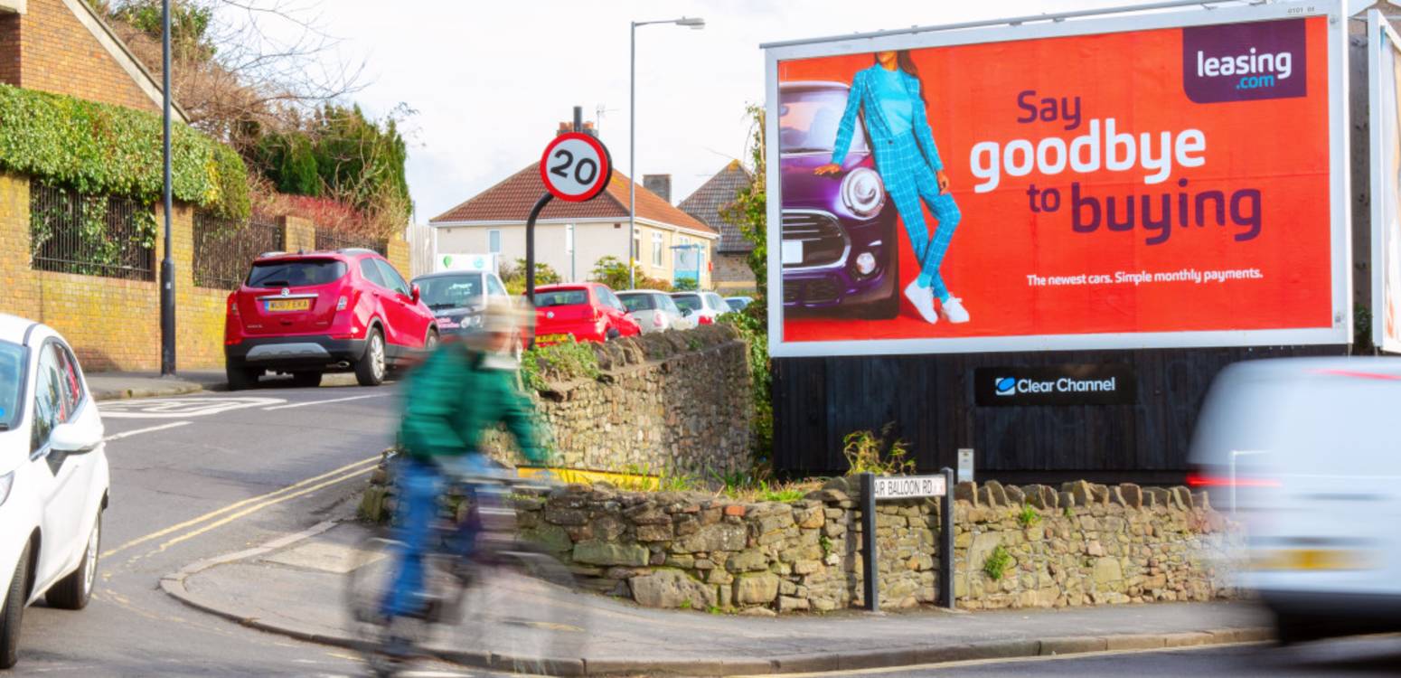 large billboard by road with leasing.com advert