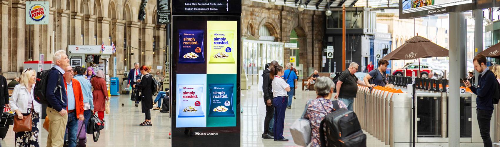 Digital poster advertising on a train station concours area