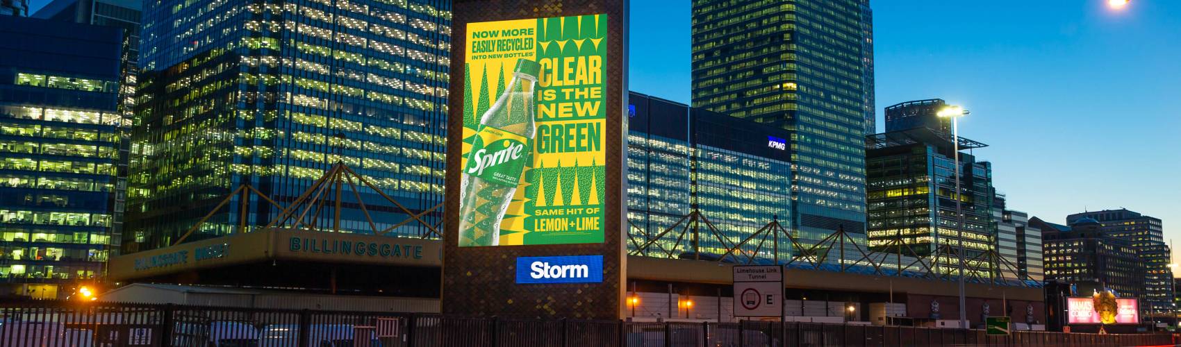 Yellow and green Sprite Storm ad at night with cars driving past