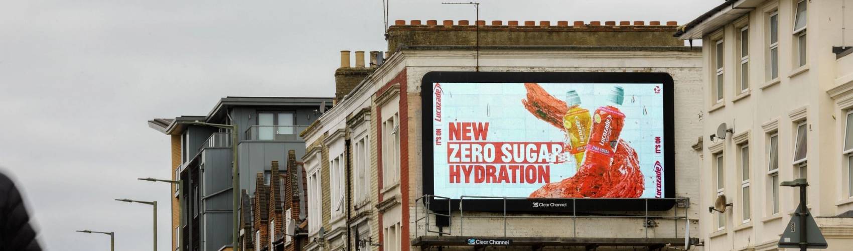 Large billboard showing ad for Lucozade