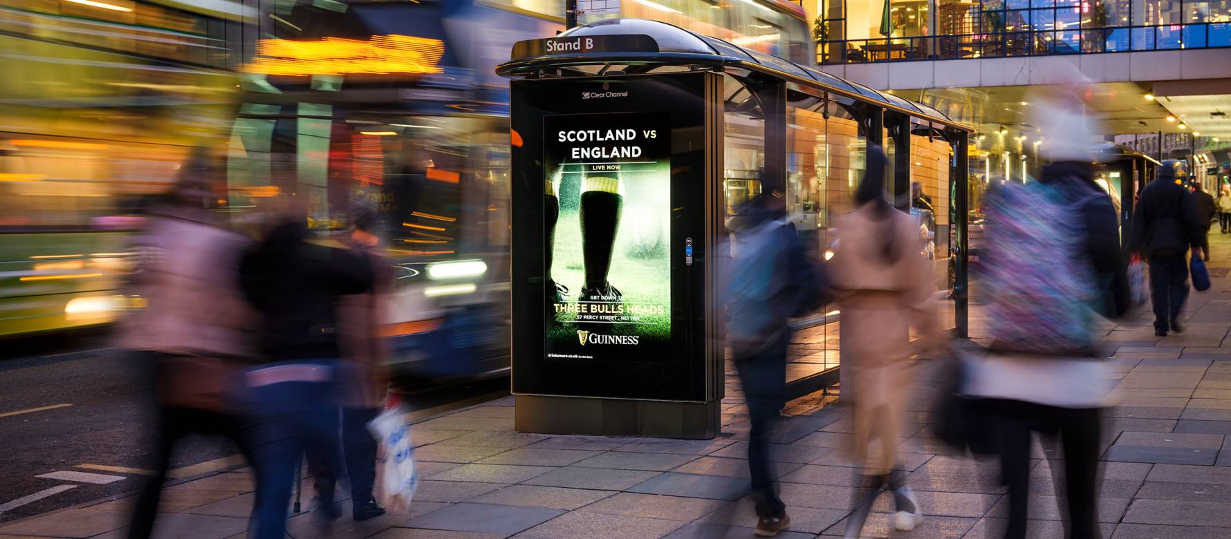 Adshel screen displays rugby sock with Guinness colouring in city setting