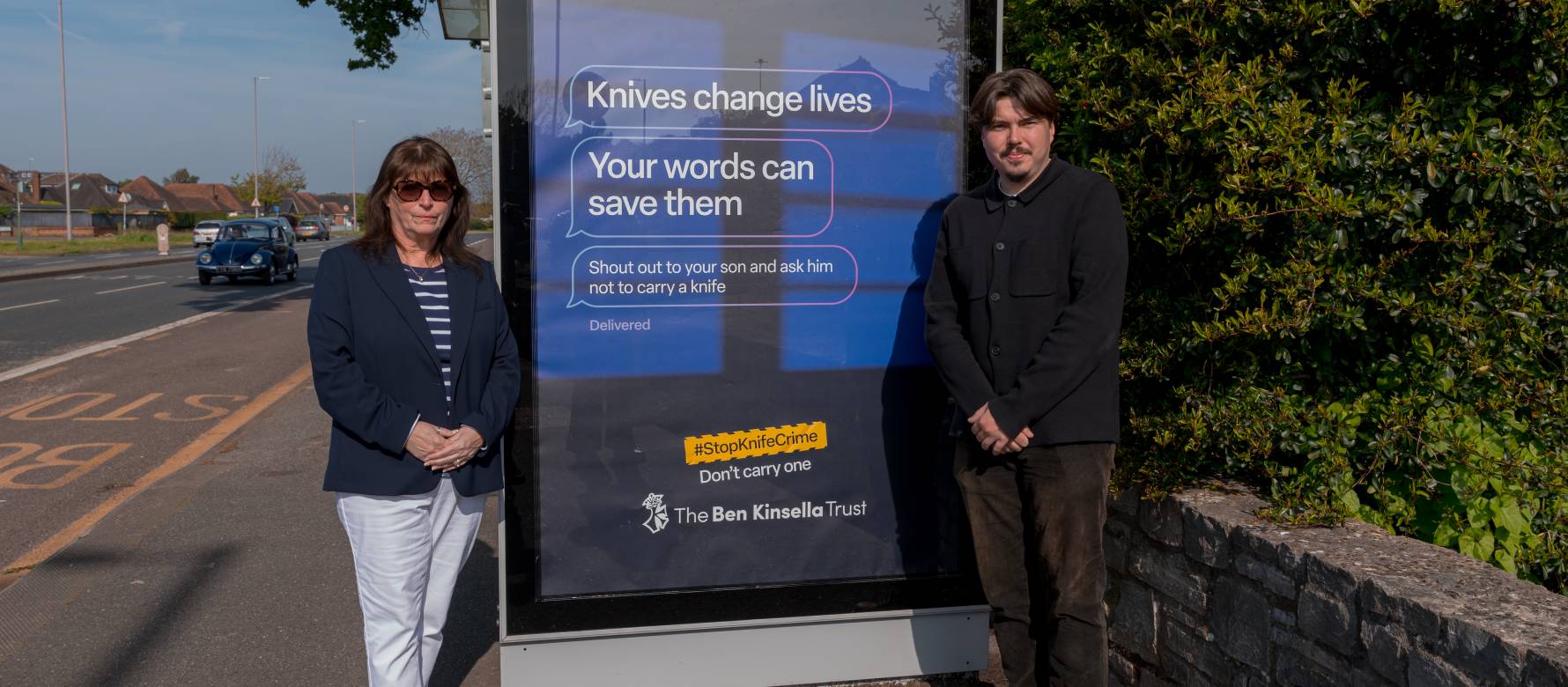 Members of BCP council in Bournemouth, during the day, in front of a digital screen displaying the Ben Kinsella campaign messaging