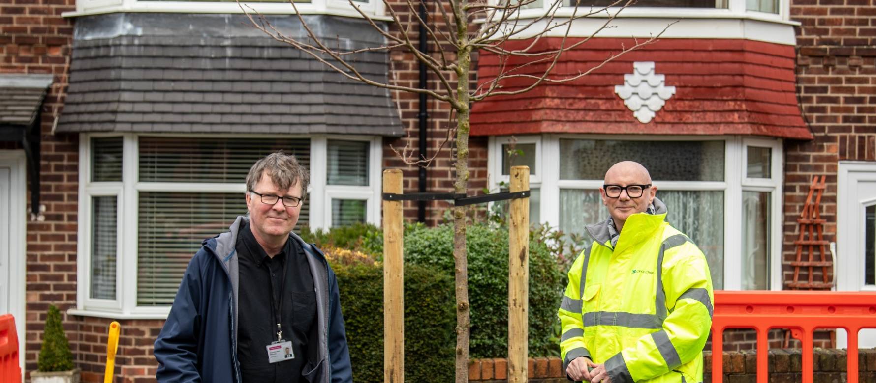 Photo of two people planting a tree in Salford funded by Clear Channel