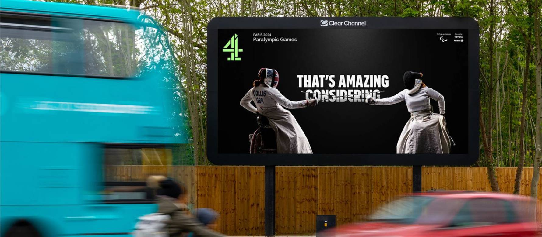 Vehicles drive past a Channel 4 Paralympic ad on a large billboard