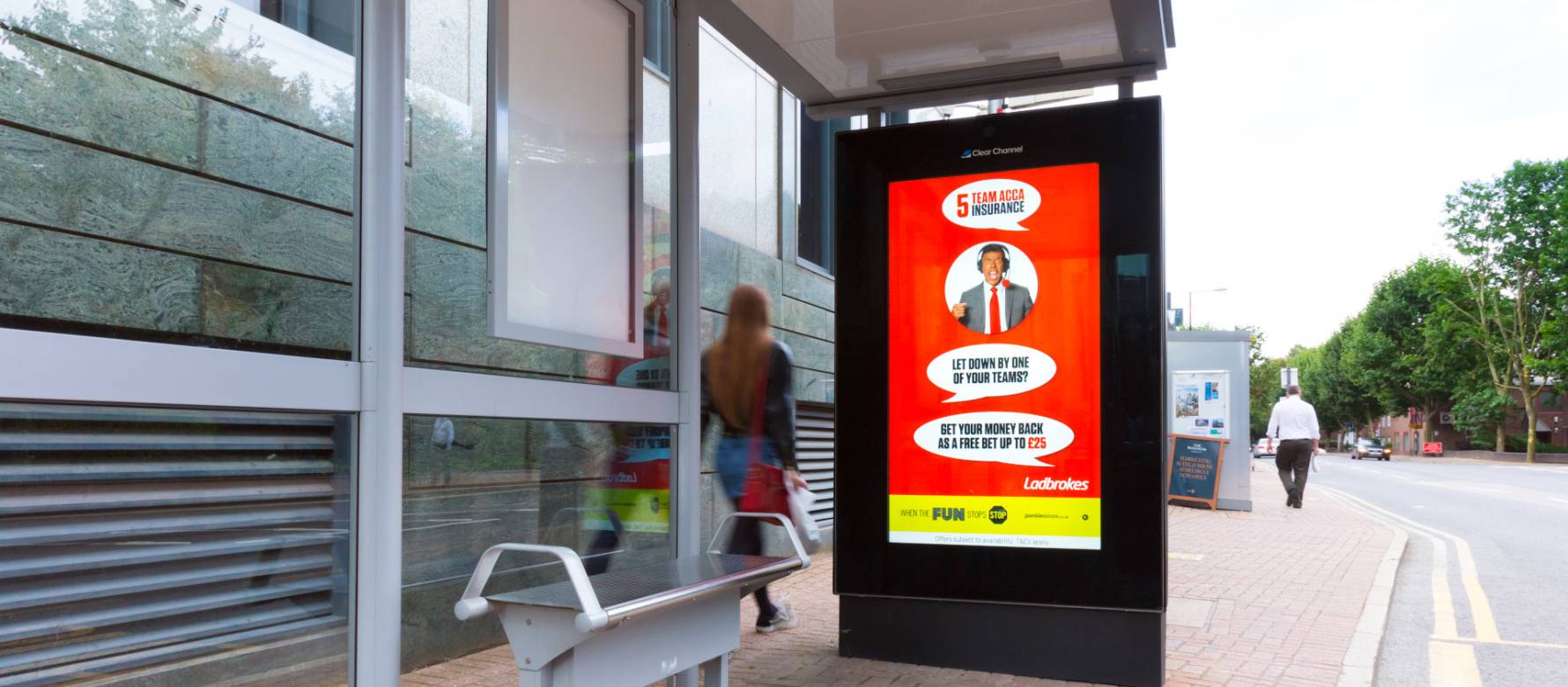 Clear Channel digital screen on bus stop showing Ladbrokes Advert