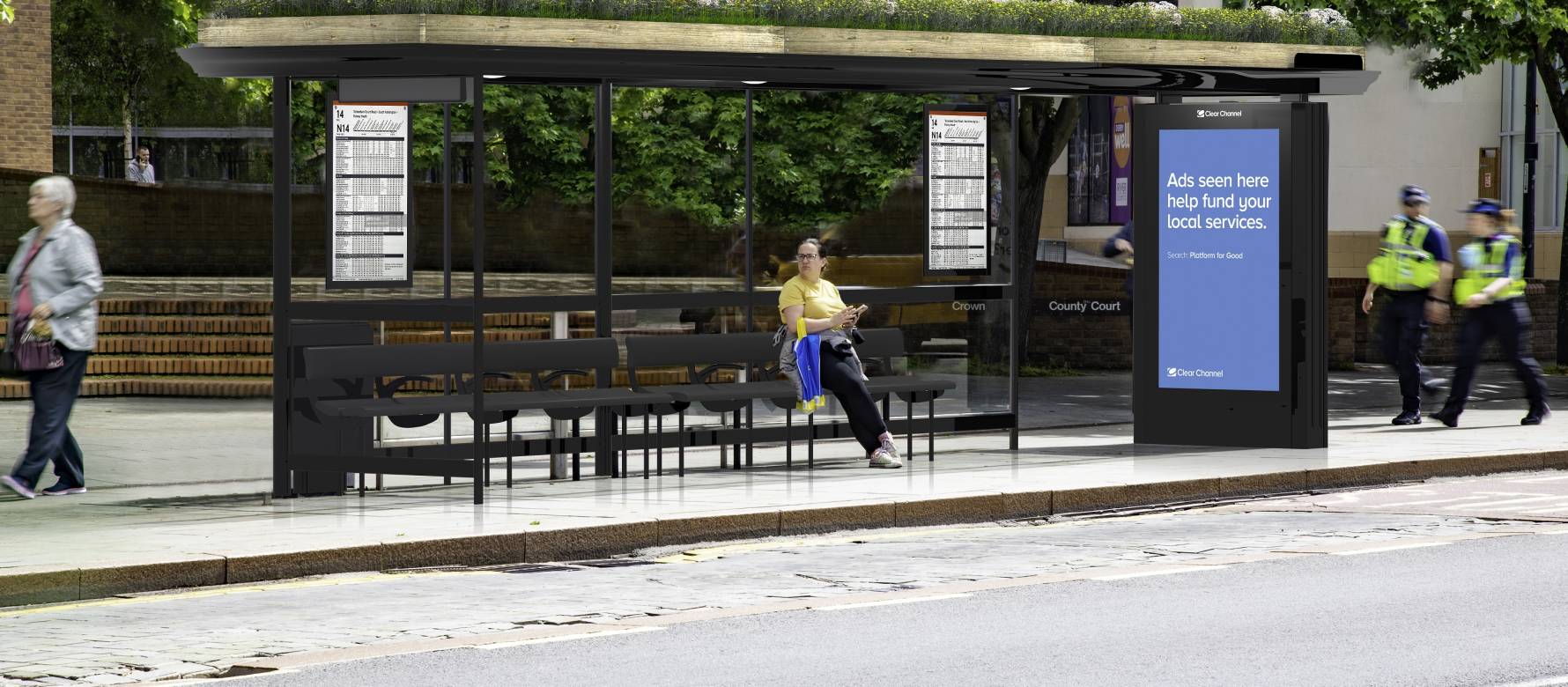 Clear Channel 'Living Roof' bus shelter with blue image on screen with people walking by