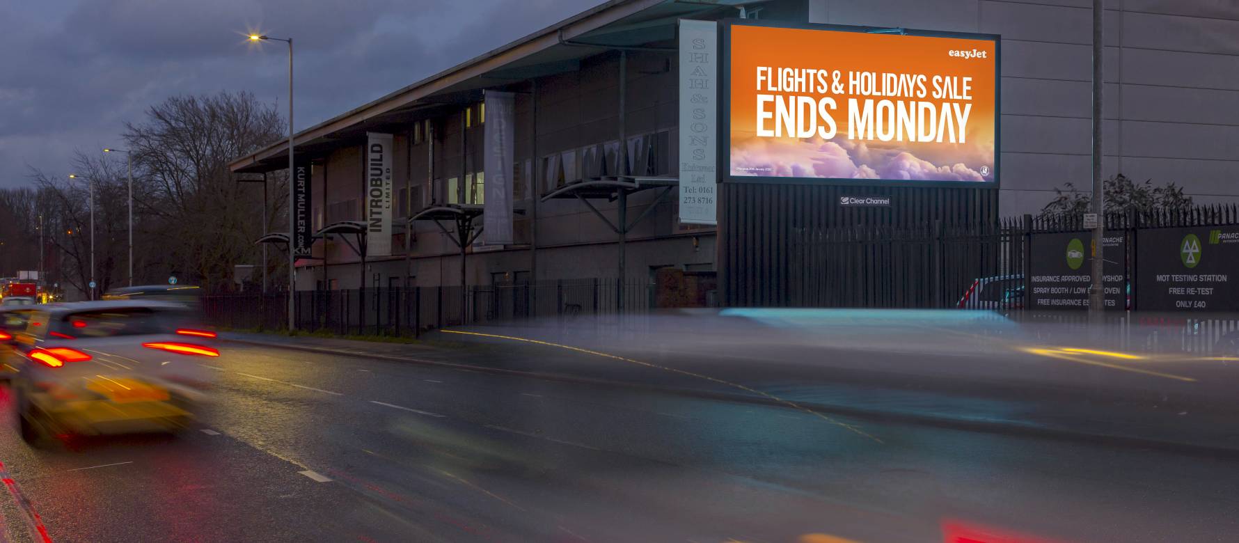 A building with a large billboard live screen advertising easy jet.