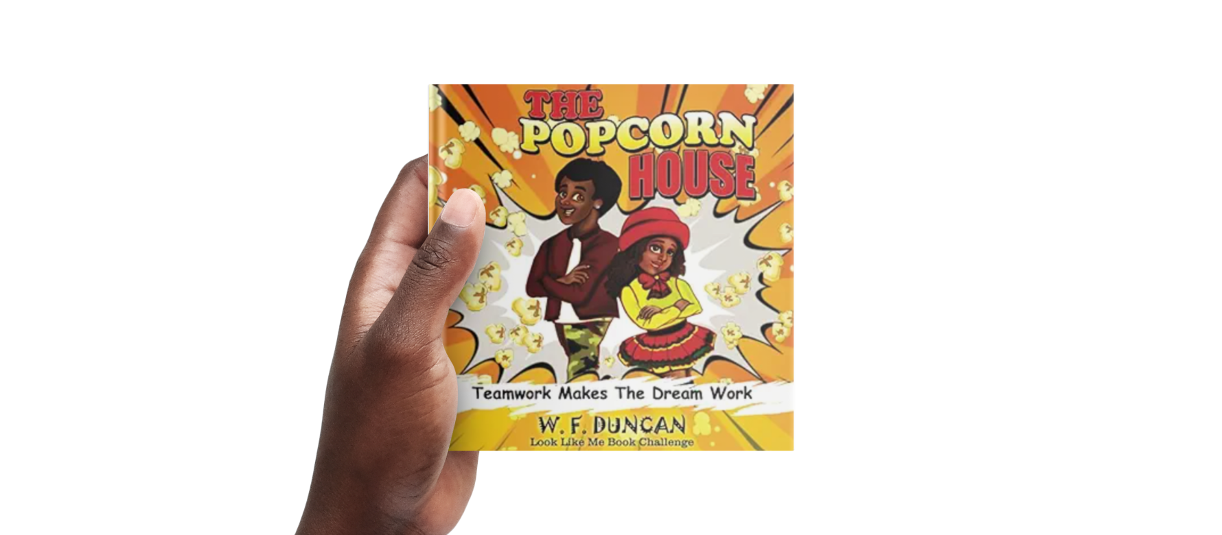 A child's hand holding a book entitled 'The Popcorn House' in front of a black background