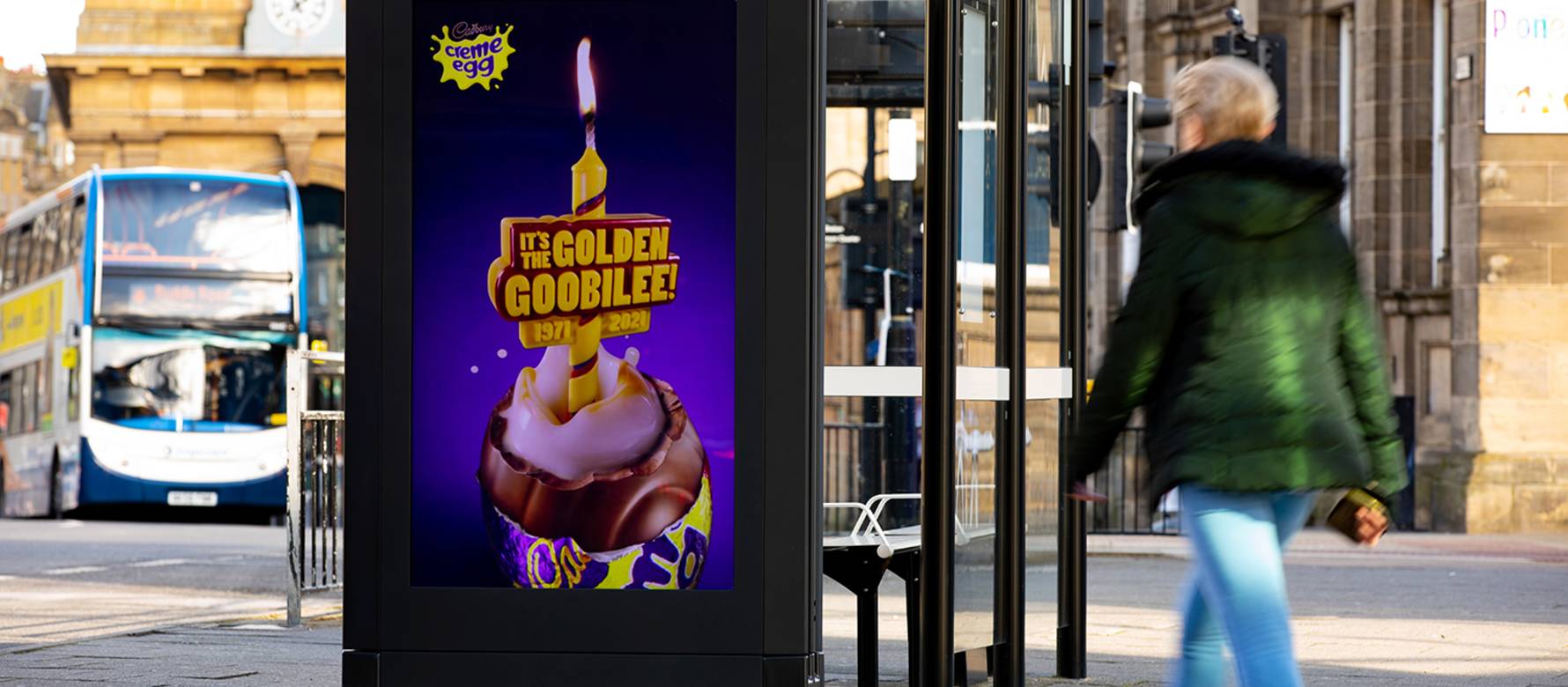 Cadburys advert on Ashel Live poster on bus stop